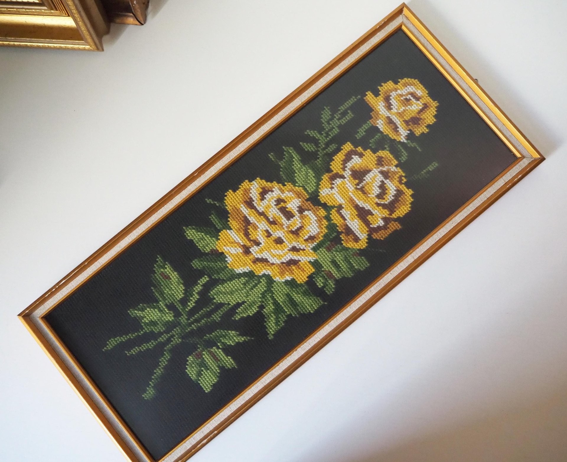 vintage needlepoint wall art with yellow roses
